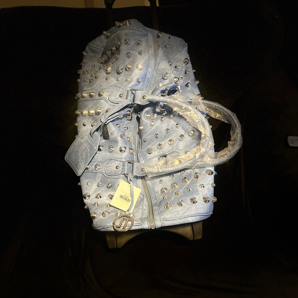 Traci Lynn Blue Travel Bag with Structured Design on wheels